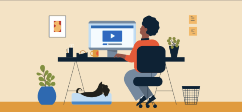 Cartoon individual sitting at a desk watching trainings
